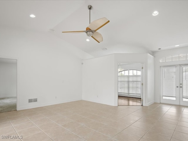 unfurnished living room featuring french doors, light tile patterned floors, vaulted ceiling, and ceiling fan