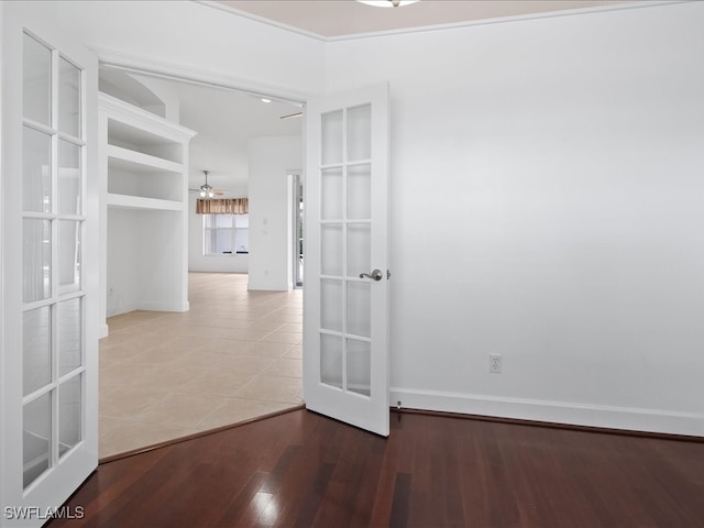 empty room featuring hardwood / wood-style flooring, ceiling fan, and french doors