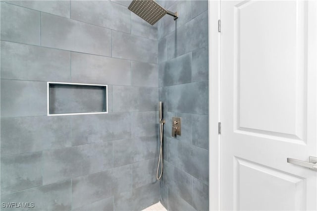 bathroom with tiled shower