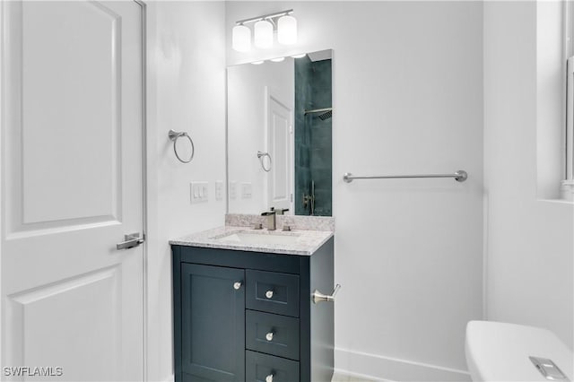 bathroom with vanity, toilet, and walk in shower