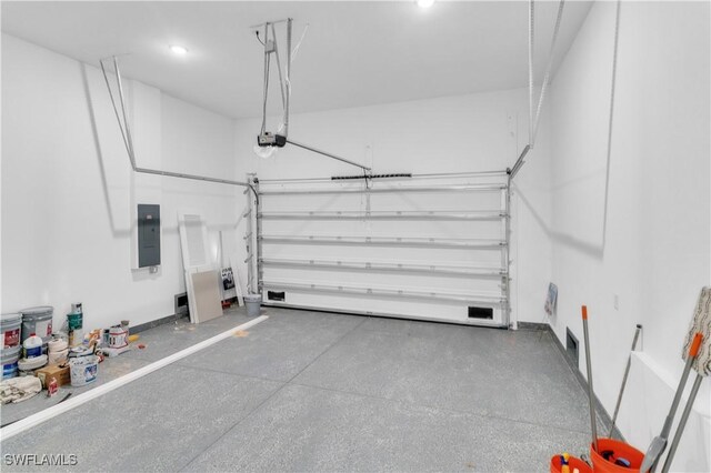 garage featuring electric panel and a garage door opener