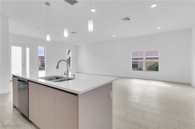 kitchen with sink, pendant lighting, a center island with sink, dishwasher, and light tile patterned flooring