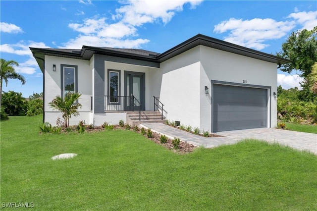 view of front facade with a garage and a front lawn