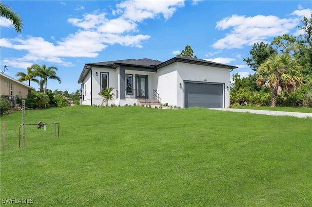 view of front of house with a front yard and a garage