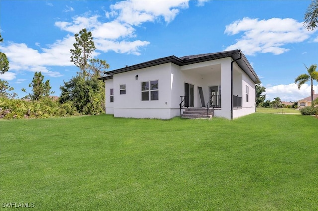 back of house featuring a yard