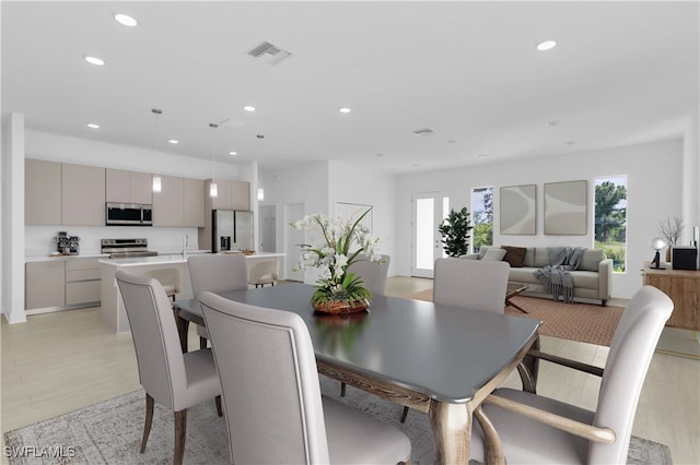 dining area featuring light wood-type flooring