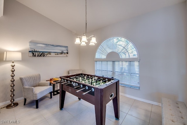 rec room featuring light tile patterned flooring, a chandelier, and vaulted ceiling