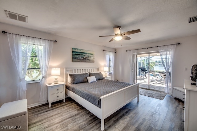 bedroom with hardwood / wood-style floors, ceiling fan, access to exterior, and multiple windows