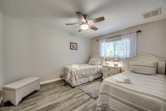 bedroom with hardwood / wood-style floors and ceiling fan