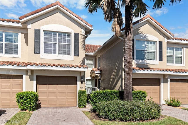 mediterranean / spanish-style home with a garage