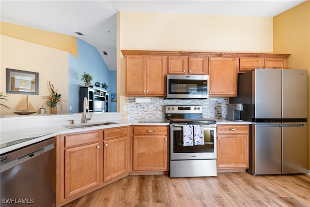 kitchen featuring decorative backsplash, light hardwood / wood-style floors, sink, and stainless steel appliances