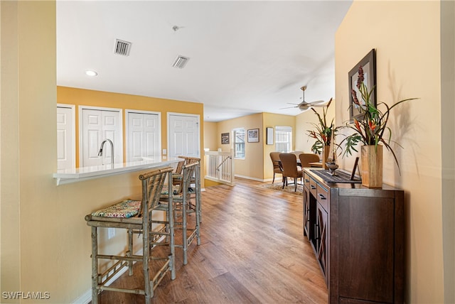 interior space with ceiling fan and light hardwood / wood-style floors