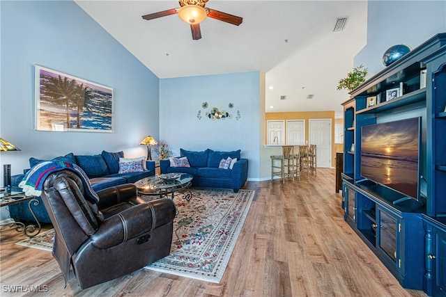 living room featuring ceiling fan, high vaulted ceiling, and light hardwood / wood-style floors