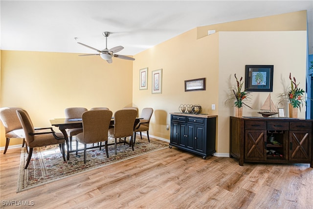 dining area with light wood-type flooring, ceiling fan, and lofted ceiling