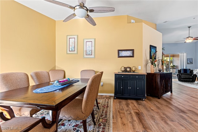 dining area with ceiling fan and hardwood / wood-style flooring