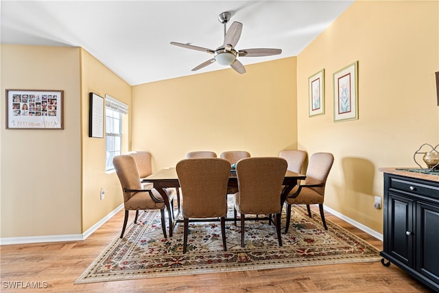 dining room featuring light wood-type flooring, ceiling fan, and lofted ceiling