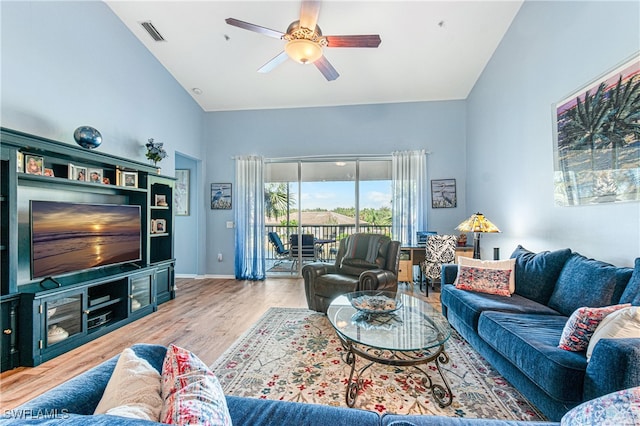 living room with ceiling fan, high vaulted ceiling, and hardwood / wood-style flooring