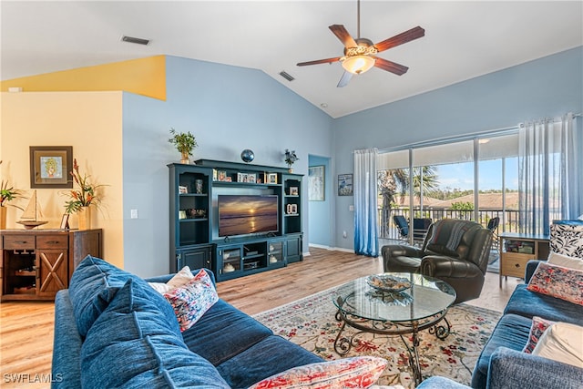 living room with wood-type flooring, ceiling fan, and lofted ceiling