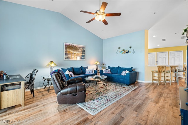 living room featuring lofted ceiling, ceiling fan, and wood-type flooring