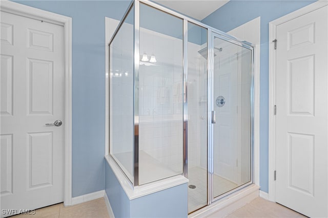 bathroom with tile patterned floors and walk in shower