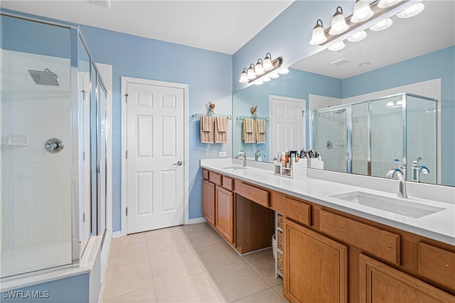 bathroom with tile patterned flooring, vanity, and an enclosed shower