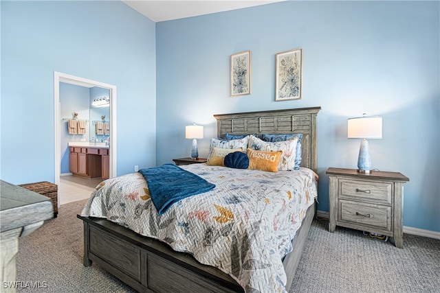 carpeted bedroom featuring ensuite bath