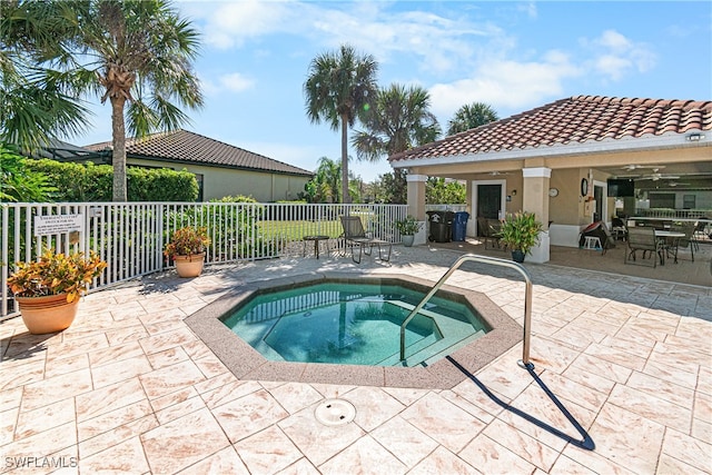 view of pool featuring a patio area and an in ground hot tub