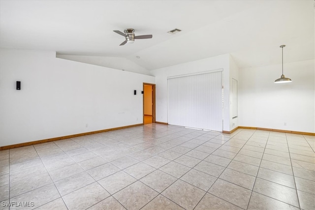 tiled spare room featuring vaulted ceiling and ceiling fan