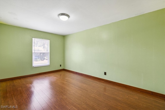 empty room with wood-type flooring