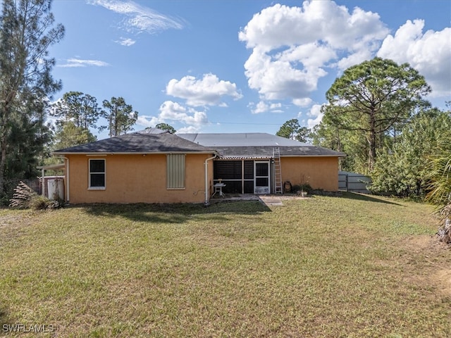 rear view of house with a yard