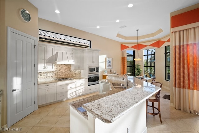 kitchen featuring white cabinetry, sink, an island with sink, and stainless steel appliances