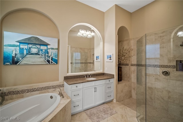 bathroom with tile patterned flooring, vanity, and separate shower and tub