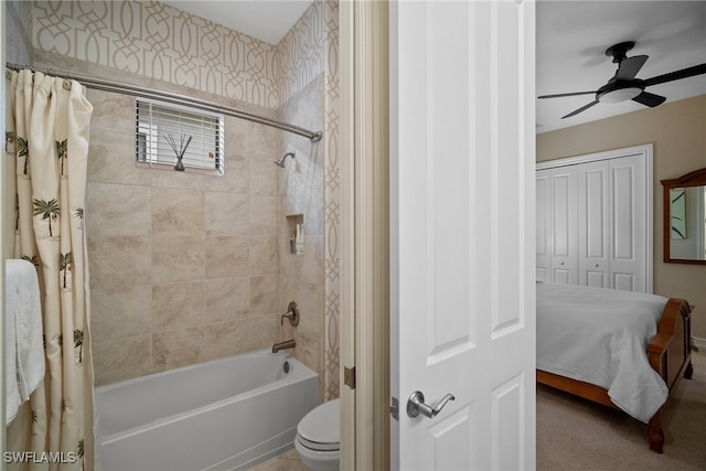 bathroom featuring toilet, ceiling fan, and shower / bath combo with shower curtain