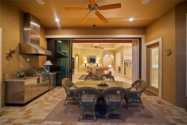 dining room featuring ceiling fan and sink