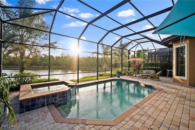 view of swimming pool with an in ground hot tub, a water view, glass enclosure, and a patio area