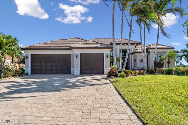 view of front of property with a garage and a front lawn