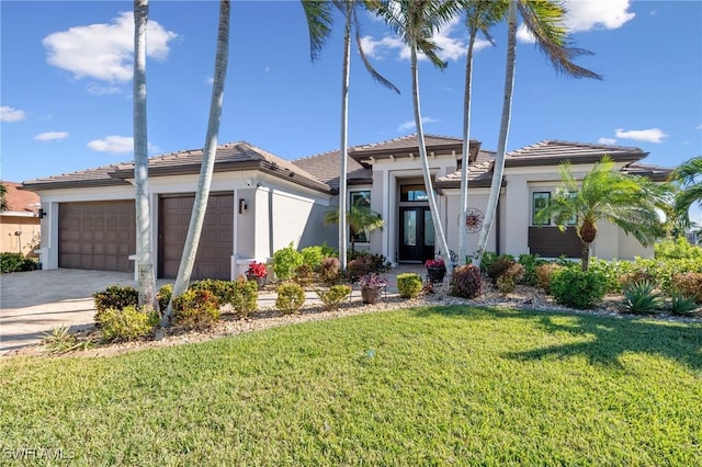 view of front of home with a garage and a front lawn