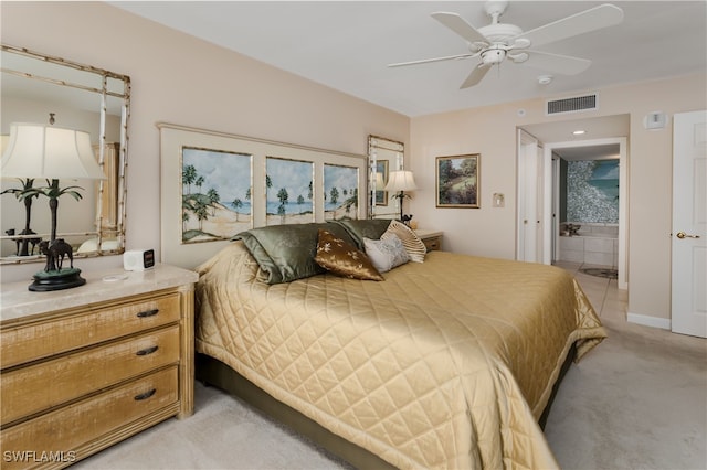 bedroom with ensuite bathroom, ceiling fan, and light carpet