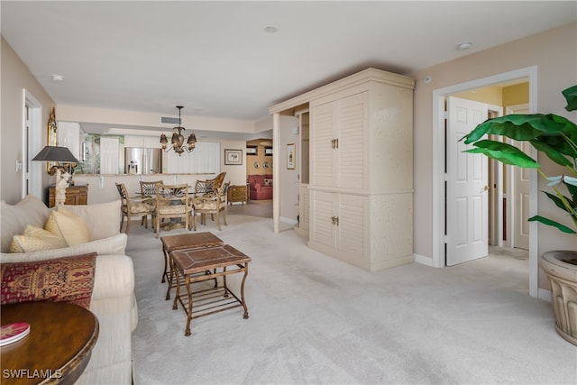 living room with a notable chandelier and light carpet