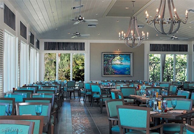 dining area featuring lofted ceiling, ceiling fan with notable chandelier, and wood ceiling