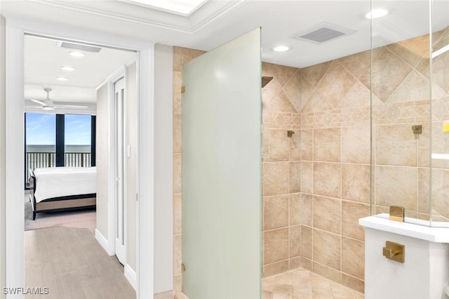 bathroom featuring tiled shower and tile walls