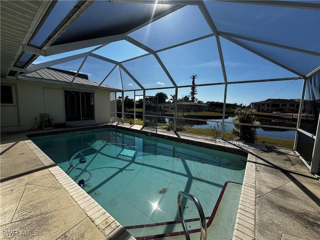 view of pool featuring a patio area, glass enclosure, and a water view