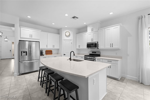 kitchen featuring sink, white cabinets, a center island with sink, and appliances with stainless steel finishes