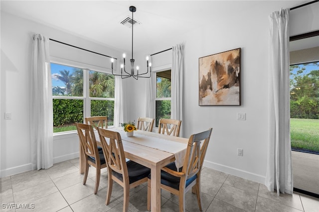 dining space featuring light tile patterned floors and an inviting chandelier