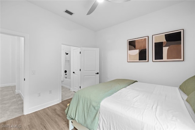 bedroom with ensuite bath, ceiling fan, and light hardwood / wood-style floors