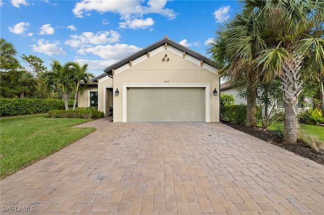 view of front of house with a garage and a front lawn