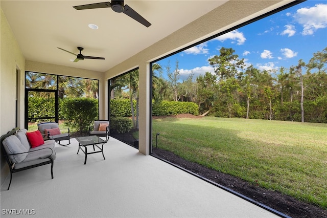 sunroom / solarium featuring ceiling fan