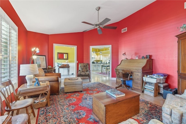 living room with ceiling fan and lofted ceiling