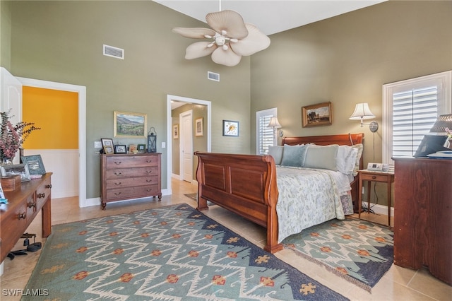 tiled bedroom featuring ceiling fan and high vaulted ceiling