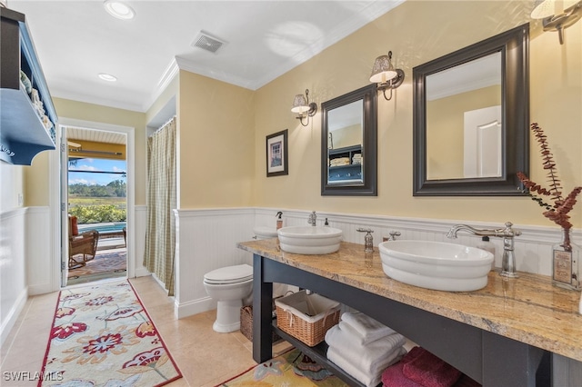 bathroom with tile patterned flooring, vanity, toilet, and ornamental molding